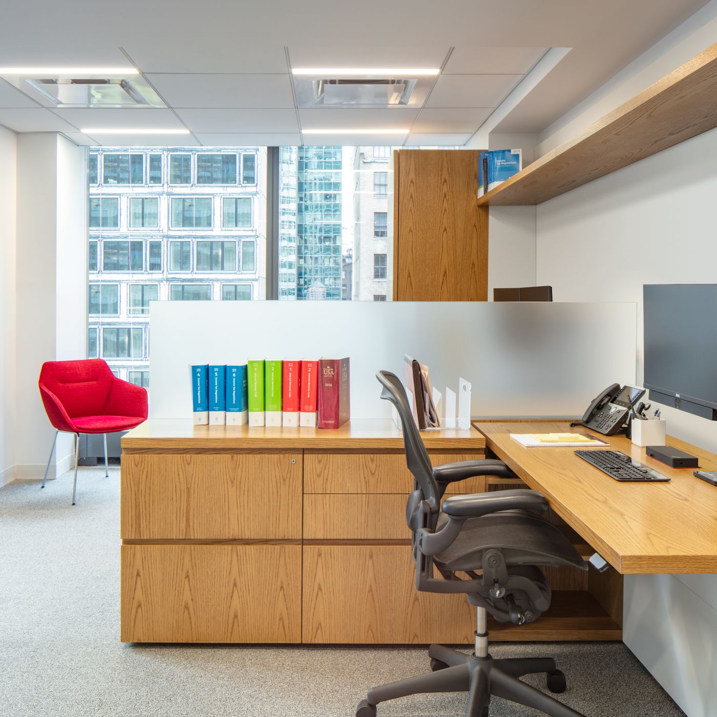 A shared NEW MILLENNIA office features adjustable-height worksurfaces and integral finger pulls.